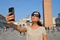 A beautiful young woman taking herself a selfie in Venice, Italy Royalty Free Stock Photo