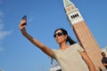 A beautiful young woman taking herself a selfie in Venice, Italy Royalty Free Stock Photo