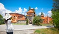 Beautiful young woman taking picture of Monastery Zica, Serbia.