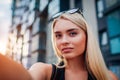 Beautiful young woman taking selfie against modern business center Royalty Free Stock Photo