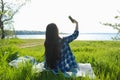 Beautiful young woman taking selfie near river Royalty Free Stock Photo