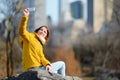 Beautiful young woman taking a selfie while sitting on a rock in Central Park Royalty Free Stock Photo