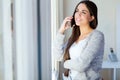 Beautiful young woman talking on the phone at home. Royalty Free Stock Photo