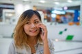 Beautiful young woman talking on the phone in the shopping mall. Royalty Free Stock Photo
