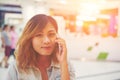 Beautiful young woman talking on the phone in the shopping mall. Royalty Free Stock Photo