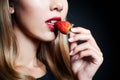 Beautiful young woman tasting strawberry Royalty Free Stock Photo