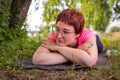 Beautiful young woman thinking and dreaming away while lying on the floor after working out on warm summer day Royalty Free Stock Photo