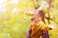 Beautiful young woman throwing leaves in a park Royalty Free Stock Photo