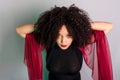 Beautiful young woman touching her hair with a red cloth Royalty Free Stock Photo