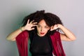 Beautiful young woman touching her hair with a red cloth Royalty Free Stock Photo