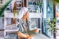 Beautiful young woman with towel on head drink coffee in the morning