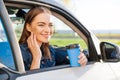 Beautiful young woman traveled on road in car, drinking coffee from disposable Royalty Free Stock Photo