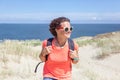 Beautiful young woman traveler with a backpack on the background Royalty Free Stock Photo