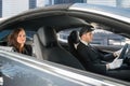 Young Woman Riding In A Car With Chauffeur Royalty Free Stock Photo