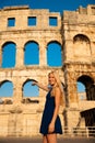 Beautiful young woman turist taking photos of roman arena in Pul Royalty Free Stock Photo