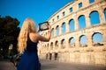 beautiful young woman turist taking photos of roman arena in Pula croatia Royalty Free Stock Photo