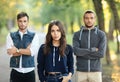 Beautiful young woman and two men behind her Royalty Free Stock Photo