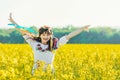 Beautiful young woman in Ukrainian embroidered standing in a field of yellow flowers Royalty Free Stock Photo