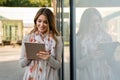 Beautiful young woman using digital tablet and smiling Royalty Free Stock Photo