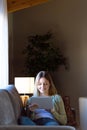 Beautiful young woman using her digital tablet at home. Royalty Free Stock Photo