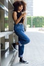 Beautiful young woman using her mobile phone in the street. Royalty Free Stock Photo