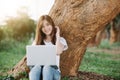 Beautiful young woman using laptop sitting in the park Royalty Free Stock Photo