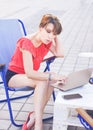 Beautiful young woman using laptop and typing outdoors Royalty Free Stock Photo