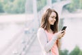 Young woman using mobile phone outdoors in a city Royalty Free Stock Photo