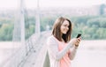 Young woman using mobile phone outdoors in a city Royalty Free Stock Photo