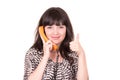 Beautiful young woman using retro orange telephone