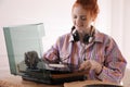 Beautiful woman using turntable at home