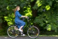 Beautiful young woman and vintage bicycle, summer. Red hair girl riding the old black retro bike outside in the park. Royalty Free Stock Photo