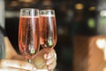 Beautiful young woman waiter serving two glasses of champagne in restaurant, cafe or bar. Bartender at work. Royalty Free Stock Photo