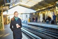 Beautiful young woman waiting for a train in Parisian underground Royalty Free Stock Photo