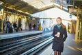 Beautiful young woman waiting for a train in Parisian underground Royalty Free Stock Photo