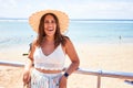 Beautiful young woman walking on beach promenade enjoying ocean view smiling happy on summer vacation Royalty Free Stock Photo