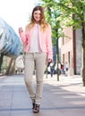 Beautiful young woman walking in the city with bag Royalty Free Stock Photo