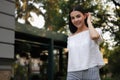 Beautiful young woman walking in green park, space for text Royalty Free Stock Photo