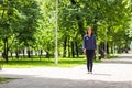Beautiful young woman walking in green summer park Royalty Free Stock Photo