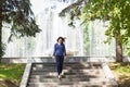 Beautiful young woman walking in green summer park Royalty Free Stock Photo