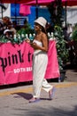 Beautiful young woman walking in Miami Beach to meet friends for spring break