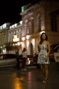 Beautiful woman is walking in the night city. Royalty Free Stock Photo