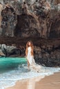 Beautiful young woman walking by the shore line Royalty Free Stock Photo