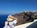 Beautiful young woman walking white streets of Thira, Santorini, Greece. Royalty Free Stock Photo