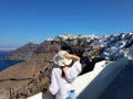 Beautiful young woman walking white streets of Thira, Santorini, Greece. Royalty Free Stock Photo