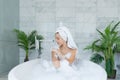 Young woman in warm bathtub with foam Royalty Free Stock Photo