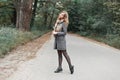 Beautiful young woman in a warm scarf and vintage coat walking Royalty Free Stock Photo