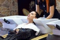 Beautiful young woman washes hair in a beauty salon.