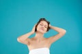 Beautiful young woman washing hair on blue background Royalty Free Stock Photo