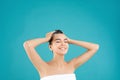 Beautiful young woman washing hair on light blue background Royalty Free Stock Photo